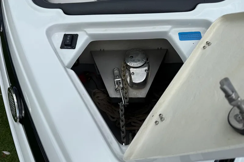 Slide: The Image of Anchor compartment of 2022 Crownline 280 SS boat with chain and winch. - 14