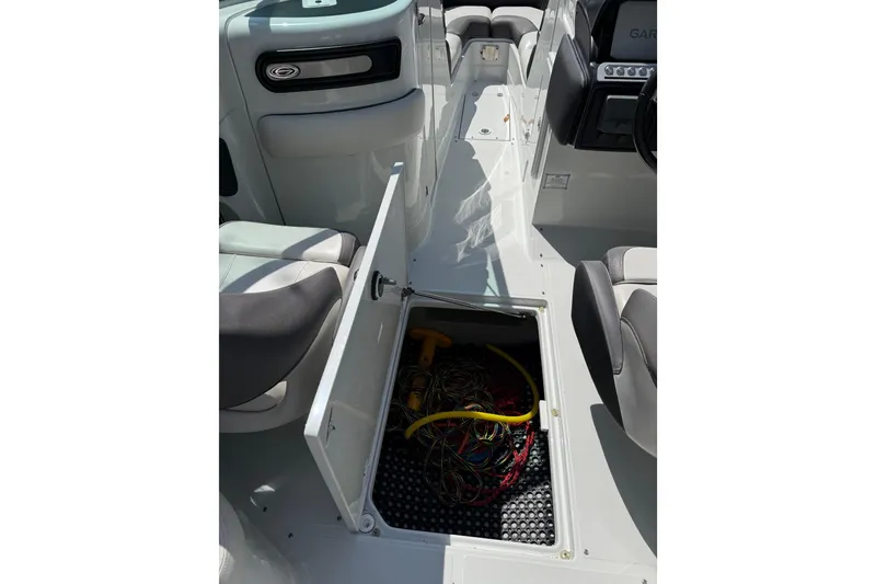 Slide: The Image of 2022 Crownline 280 SS boat interior with open storage compartment. - 20