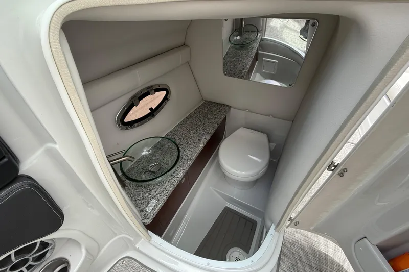Slide: The Image of 2022 Crownline 280 SS boat bathroom with modern sink, toilet, and mirror. - 24
