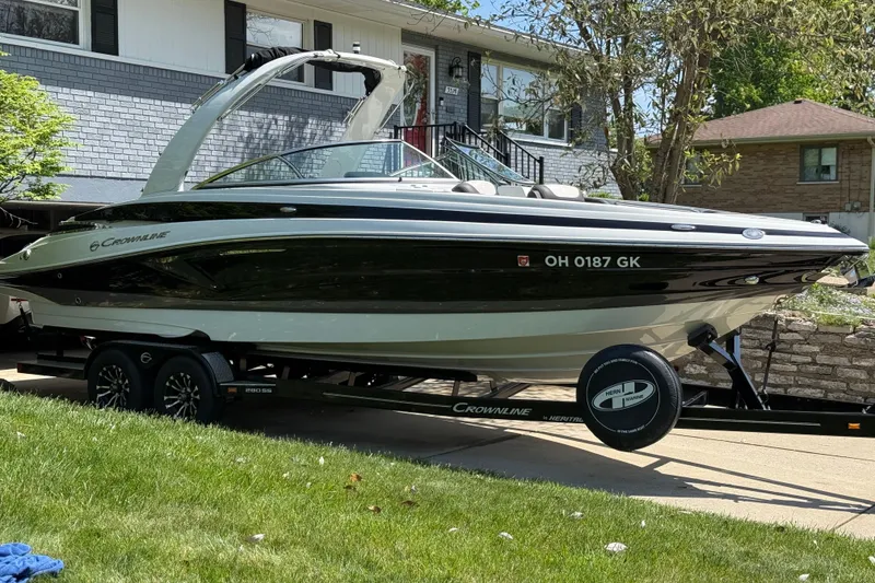Slide: The Image of 2022 Crownline 280 SS boat on trailer in residential driveway. - 3