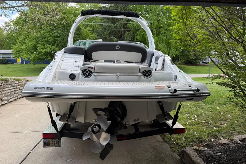 Slide: The Image of 2022 Crownline 280 SS boat on trailer, rear view with lush greenery background. - 6