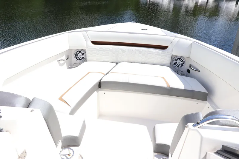 Slide: The Image of 2021 Tiara Sport 34 LX boat interior with white seating and speakers. - 16