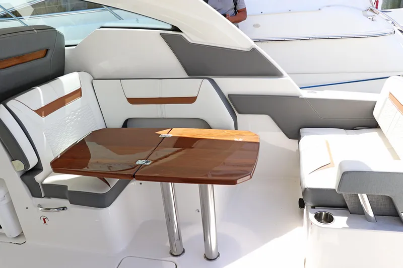 Slide: The Image of 2021 Tiara Sport 34 LX interior with elegant seating and wooden table. - 19