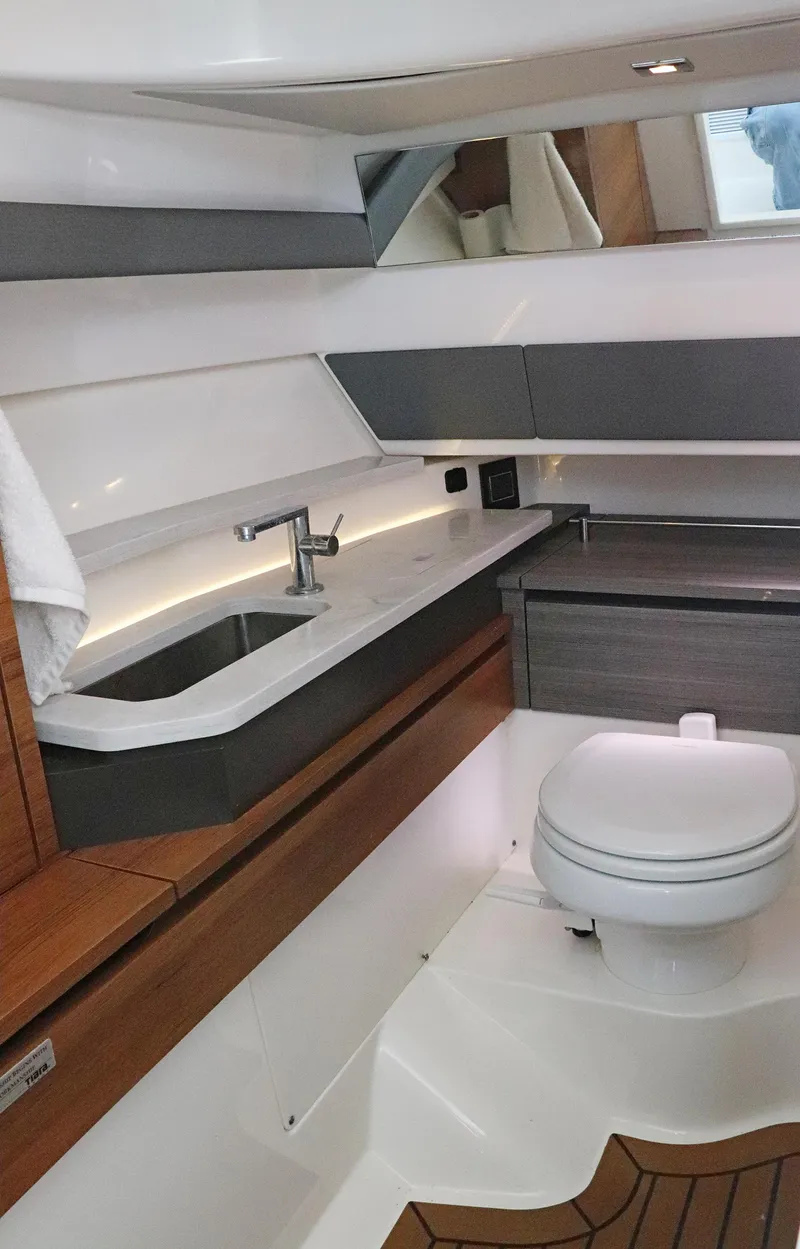 Slide: The Image of 2021 Tiara Sport 34 LX yacht interior bathroom with modern fixtures and wood accents. - 20