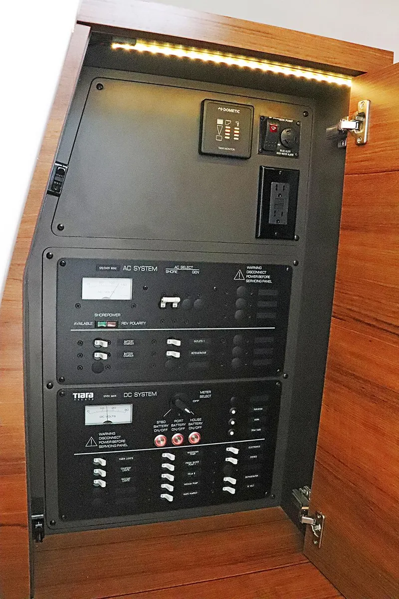 Slide: The Image of Electrical control panel inside 2021 Tiara Sport 34 LX boat, featuring AC and DC systems. - 21