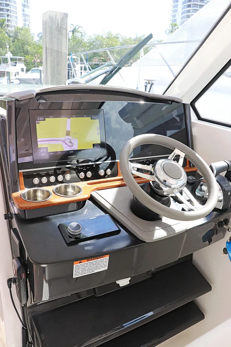 Slide: The Image of 2021 Tiara Sport 34 LX helm with modern navigation system and steering wheel. - 22