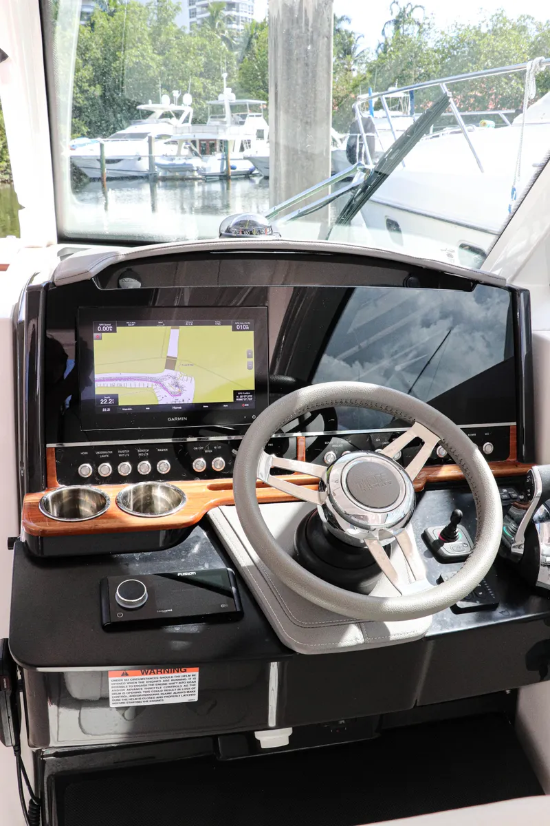 Slide: The Image of 2021 Tiara Sport 34 LX helm with modern navigation display and steering wheel. - 23