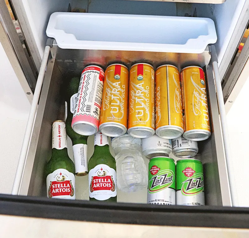Slide: The Image of Refrigerator drawer with assorted beverages, including Stella Artois and Michelob Ultra, on a Tiara Sport 34 LX. - 31