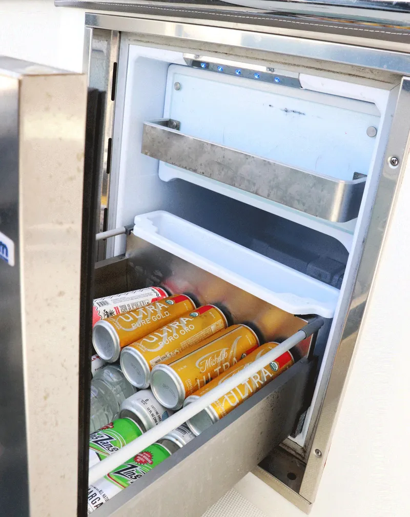 Slide: The Image of Mini fridge stocked with canned drinks on a 2021 Tiara Sport 34 LX boat. - 32
