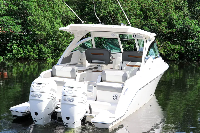 Slide: The Image of 2021 Tiara Sport 34 LX boat with dual engines on a calm waterway. - 4