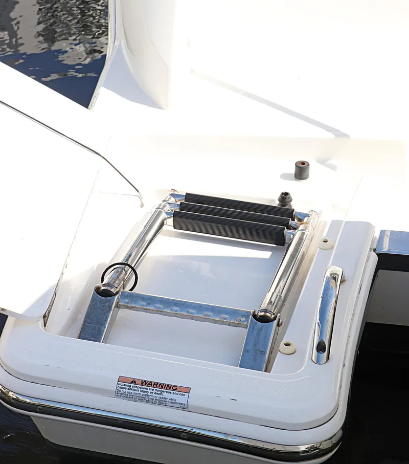 Slide: The Image of 2021 Tiara Sport 34 LX boat ladder, stainless steel, folded on deck. - 9