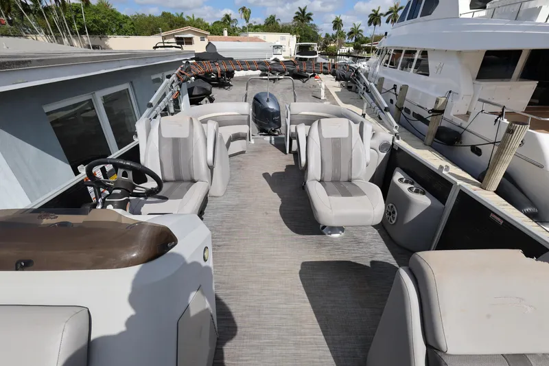Slide: The Image of 2020 Bennington SX 22 SSRX pontoon boat interior with seating and steering wheel. - 13