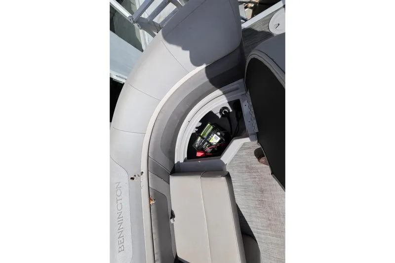 Slide: The Image of 2020 Bennington SX 22 SSRX boat seat storage compartment with visible battery. - 17
