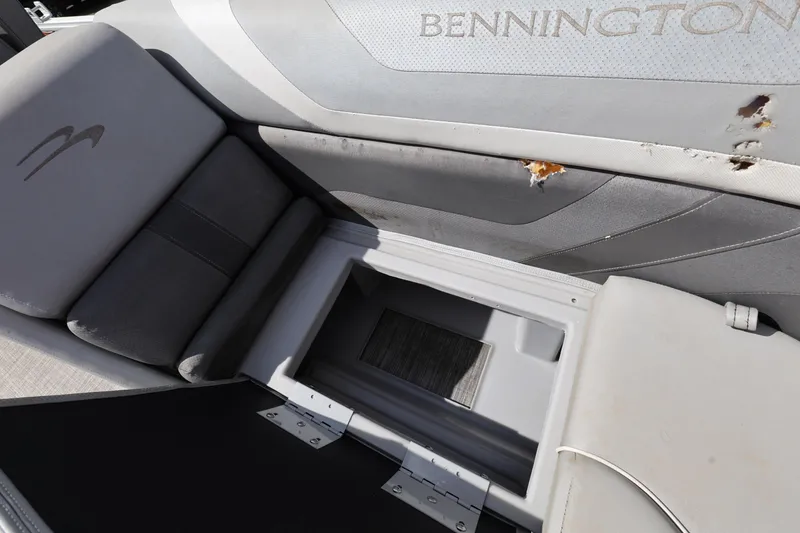 Slide: The Image of 2020 Bennington SX 22 SSRX boat interior with damaged upholstery and storage compartment. - 18