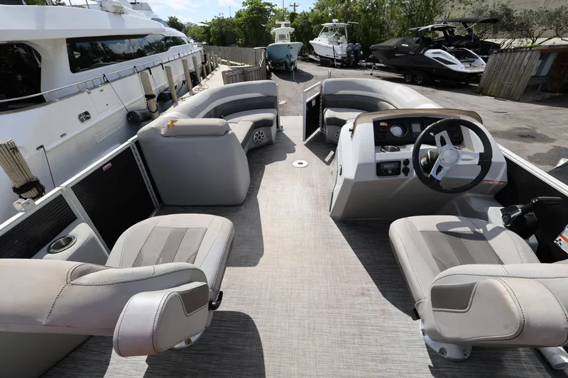 Slide: The Image of 2020 Bennington SX 22 SSRX pontoon boat interior with steering wheel and seating. - 20