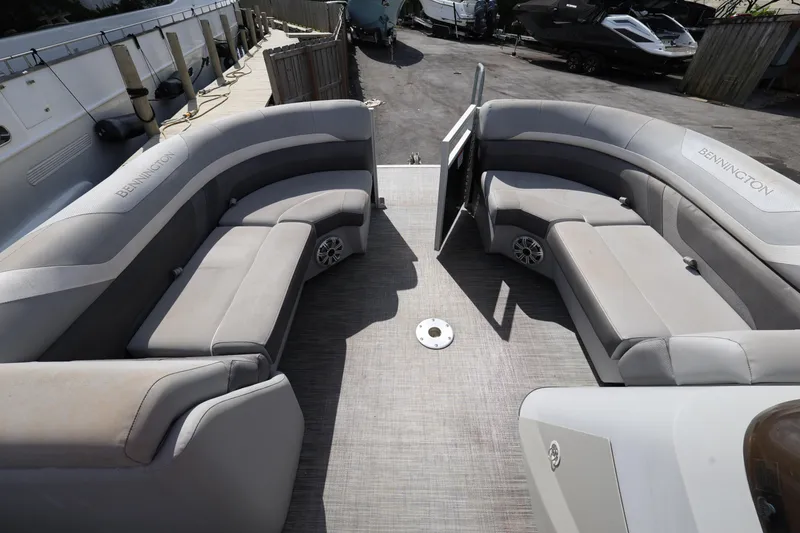 Slide: The Image of 2020 Bennington SX 22 SSRX pontoon boat interior with gray seating and spacious layout. - 23