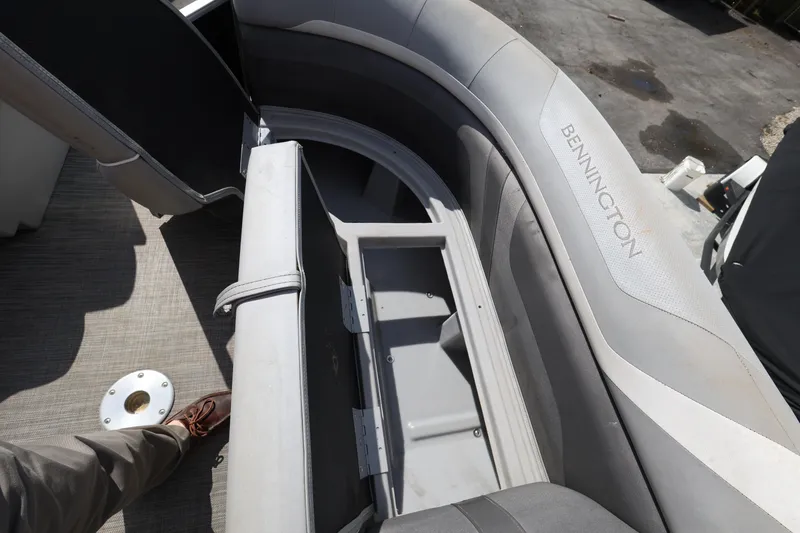 Slide: The Image of 2020 Bennington SX 22 SSRX boat interior with open storage compartment and seating. - 24