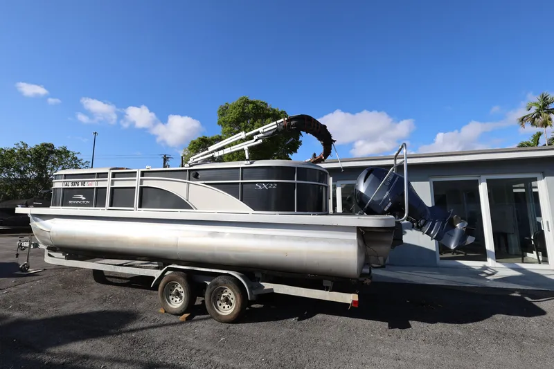 Slide: The Image of 2020 Bennington SX 22 SSRX pontoon boat on trailer, parked outdoors. - 4