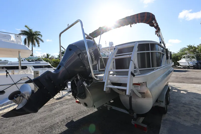 Slide: The Image of 2020 Bennington SX 22 SSRX pontoon boat with Yamaha outboard motor, docked under sunny skies. - 7