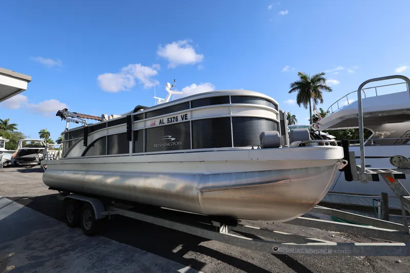 Slide: The Image of 2020 Bennington SX 22 SSRX pontoon boat on trailer under clear blue sky. - 9