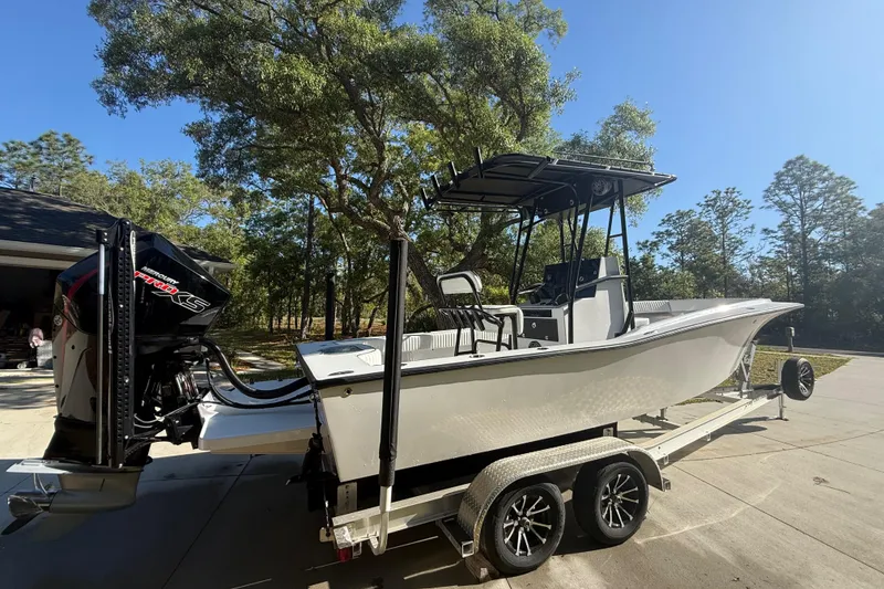 Slide: The Image of 1984 Chris-Craft 213 Scorpion boat on trailer, parked outdoors under clear sky. - 12
