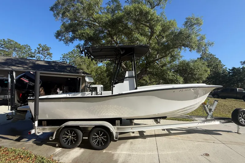 Slide: The Image of 1984 Chris-Craft 213 Scorpion boat on trailer, parked outdoors under a tree. - 13