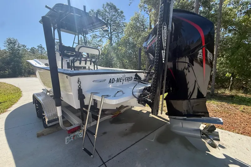 Slide: The Image of 1984 Chris-Craft 213 Scorpion boat on trailer, featuring powerful outboard motor. - 15