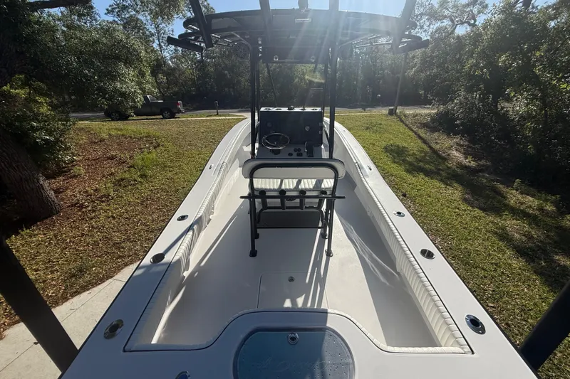 Slide: The Image of 1984 Chris-Craft 213 Scorpion boat, interior view, parked on grassy area with trees. - 17