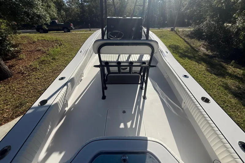 Slide: The Image of 1984 Chris-Craft 213 Scorpion boat interior, showcasing seating and steering console in sunlight. - 18