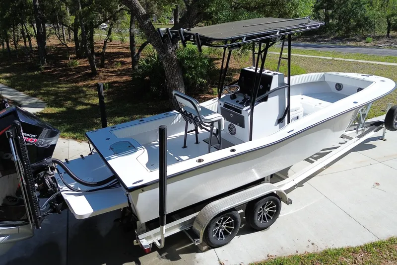 Slide: The Image of 1984 Chris-Craft 213 Scorpion boat on trailer, parked outdoors, featuring sleek design and modern equipment. - 2