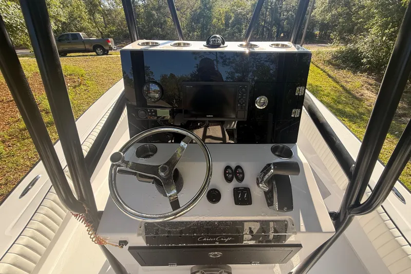 Slide: The Image of 1984 Chris-Craft 213 Scorpion boat dashboard with steering wheel and controls. - 21