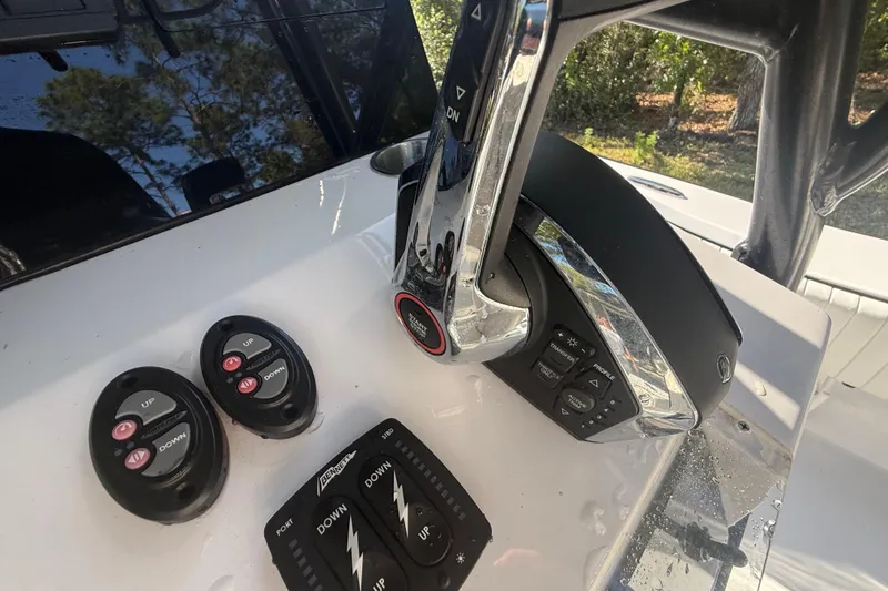 Slide: The Image of 1984 Chris-Craft 213 Scorpion boat controls with modern throttle and trim switches. - 25