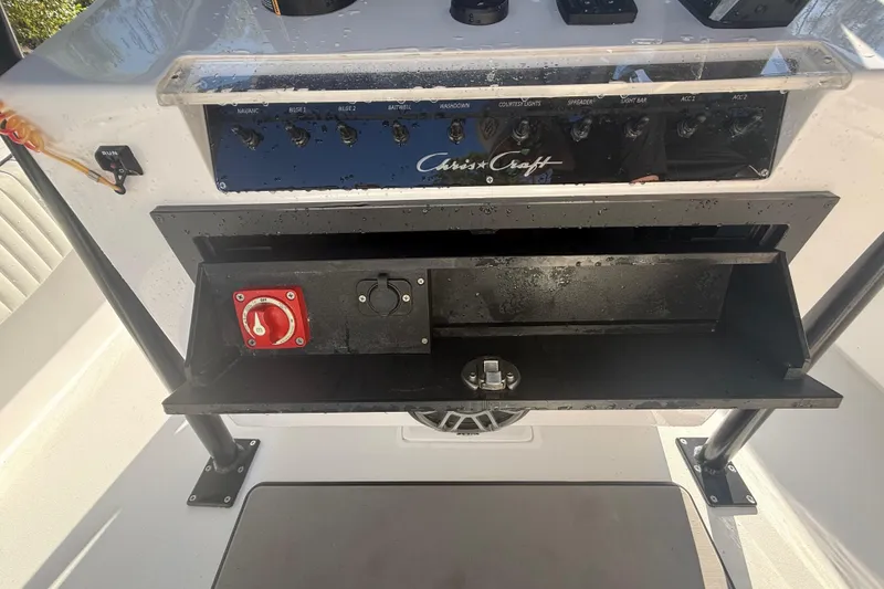 Slide: The Image of 1984 Chris-Craft 213 Scorpion dashboard with control panel and storage compartment. - 28