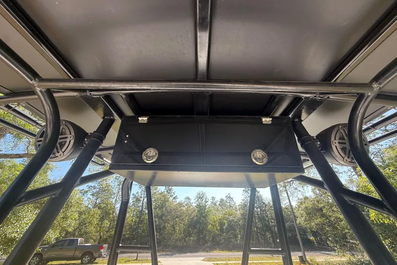 Slide: The Image of 1984 Chris-Craft 213 Scorpion boat interior with speakers and storage compartment. - 29