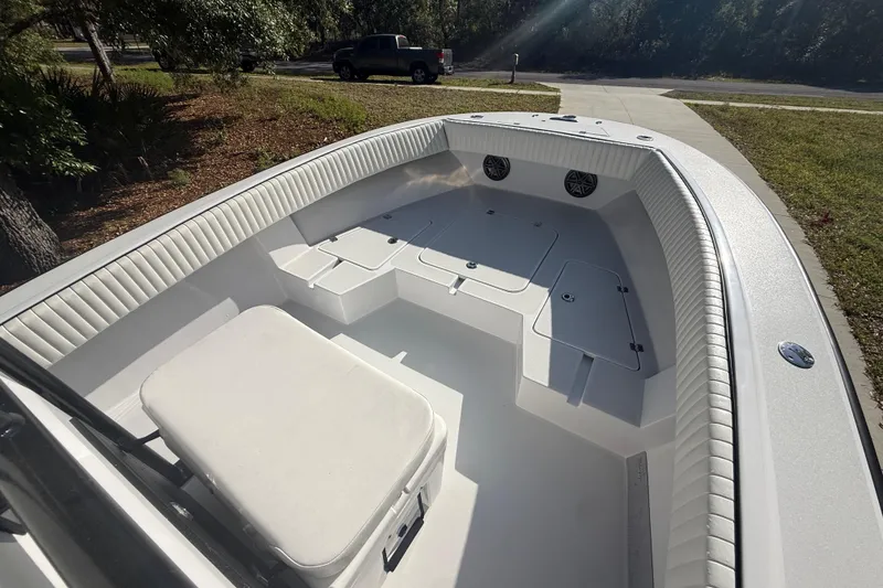 Slide: The Image of 1984 Chris-Craft 213 Scorpion boat interior with white seating and storage compartments. - 33