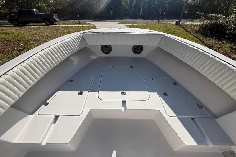 Slide: The Image of 1984 Chris-Craft 213 Scorpion boat interior with white seating and storage compartments. - 34