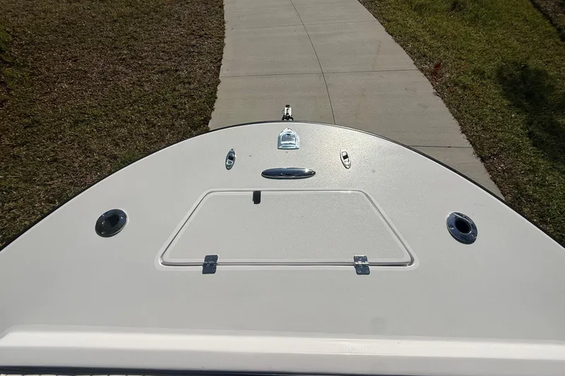 Slide: The Image of 1984 Chris-Craft 213 Scorpion boat bow on a paved path, sunny day. - 46