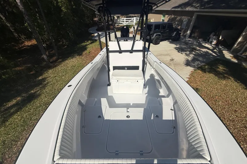 Slide: The Image of 1984 Chris-Craft 213 Scorpion boat with spacious deck and seating, parked outdoors. - 49