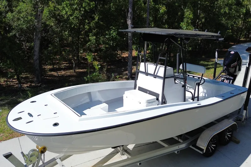 Slide: The Image of 1984 Chris-Craft 213 Scorpion boat on trailer, surrounded by trees. - 5