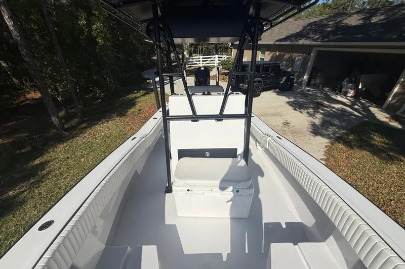 Slide: The Image of 1984 Chris-Craft 213 Scorpion boat interior with seating and console, parked outdoors. - 50