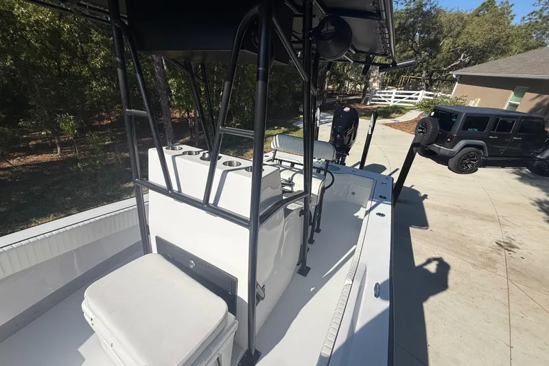 Slide: The Image of 1984 Chris-Craft 213 Scorpion boat on driveway, with trees and a Jeep in the background. - 55