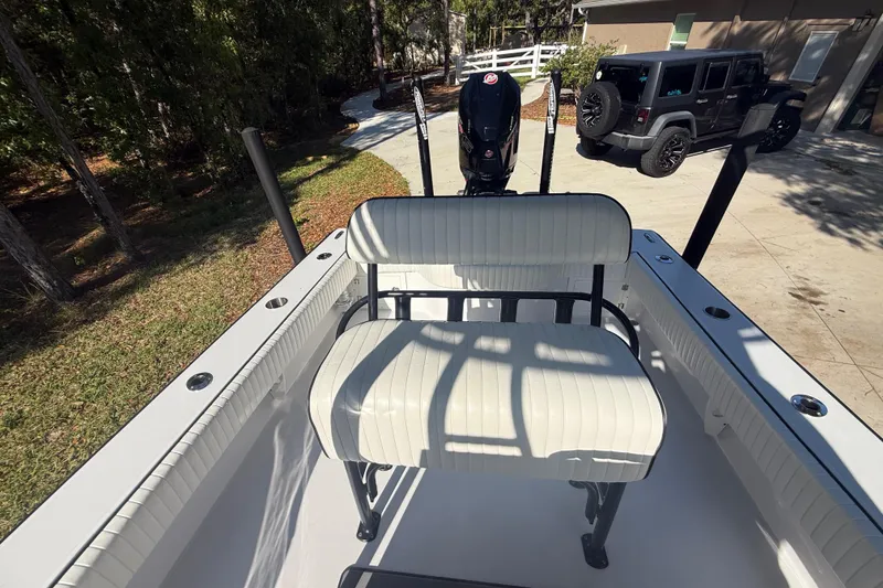 Slide: The Image of 1984 Chris-Craft 213 Scorpion boat with white seating, parked near a Jeep in a driveway. - 59