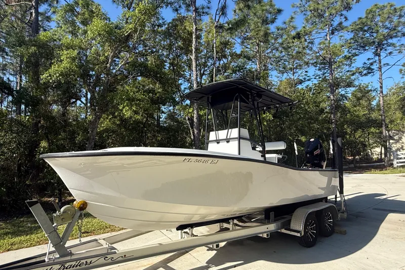 Slide: The Image of 1984 Chris-Craft 213 Scorpion boat on trailer, surrounded by trees. - 6