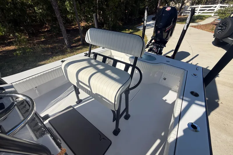 Slide: The Image of 1984 Chris-Craft 213 Scorpion boat interior with seating and motor, parked outdoors. - 60