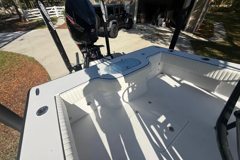 Slide: The Image of 1984 Chris-Craft 213 Scorpion boat interior with motor, parked in driveway. - 61