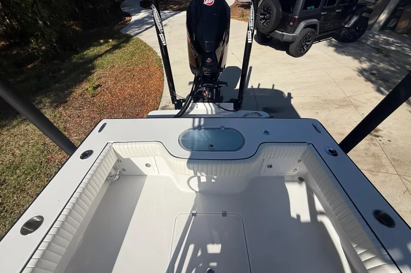 Slide: The Image of 1984 Chris-Craft 213 Scorpion boat interior with motor, parked on driveway. - 64