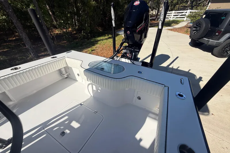 Slide: The Image of 1984 Chris-Craft 213 Scorpion boat interior with motor, parked on driveway. - 65