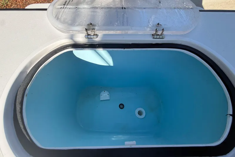 Slide: The Image of Open storage compartment on 1984 Chris-Craft 213 Scorpion boat, featuring a blue interior. - 69