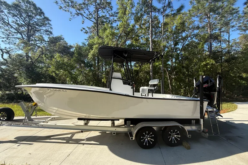 Slide: The Image of 1984 Chris-Craft 213 Scorpion boat on trailer, surrounded by trees. - 7