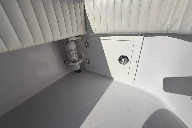 Slide: The Image of 1984 Chris-Craft 213 Scorpion interior with white upholstery and storage compartment. - 70